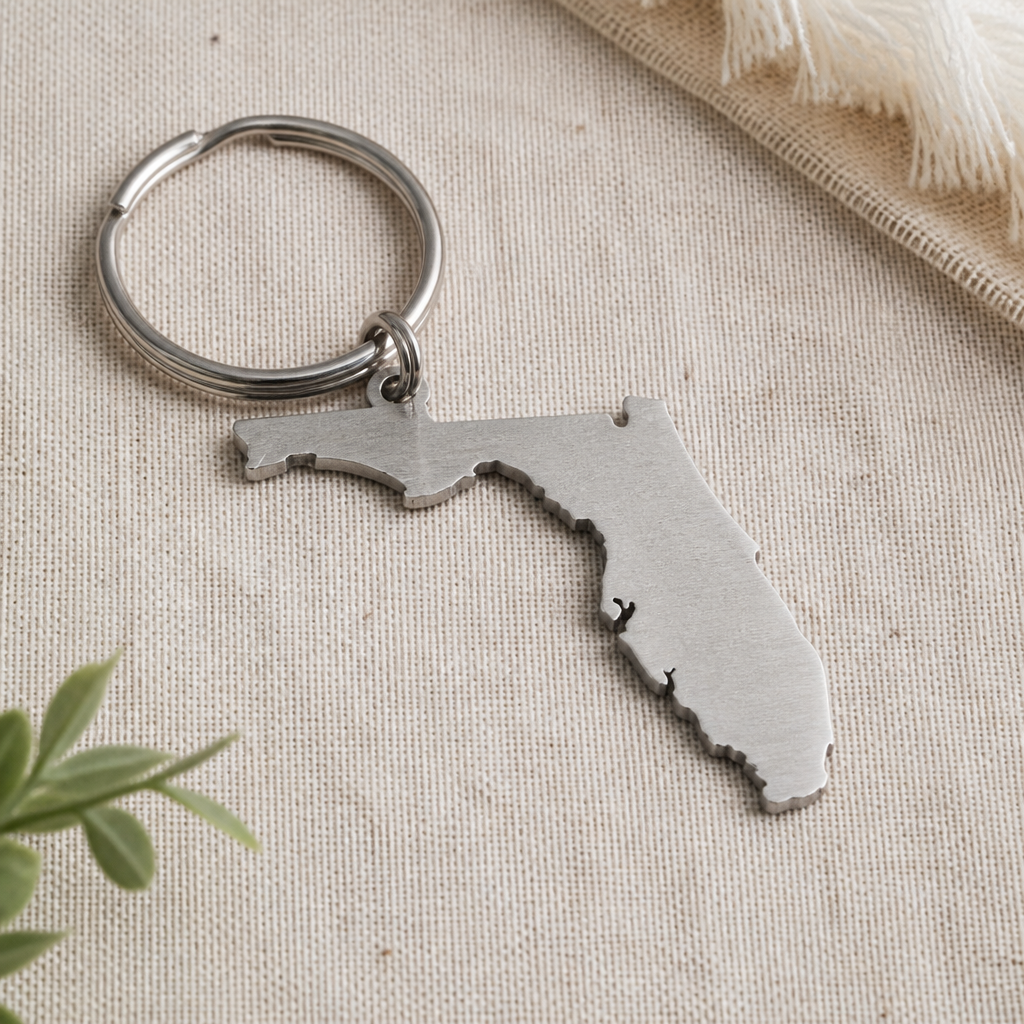 A metal Florida outline fob on a ring